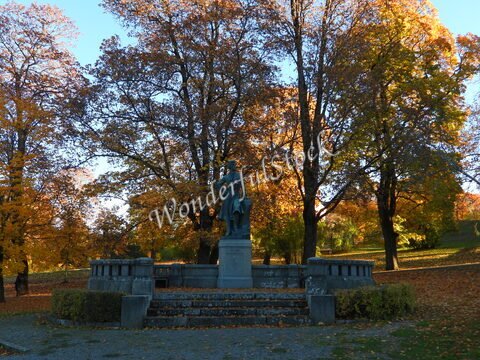 Statue dans un parc avec des arbres aux feuilles d'automne, à Uppsala, Suède.