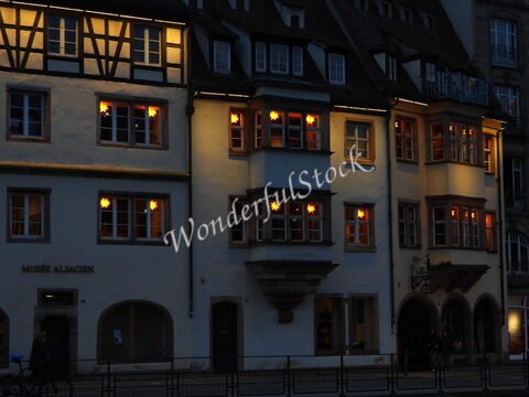 Maison illuminée avec des fenêtres décorées d'étoiles, à Strasbourg, France. Le bâtiment abrite le Musée Alsacien.